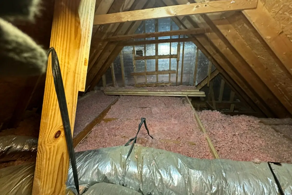Attic before: thin, patchy insulation