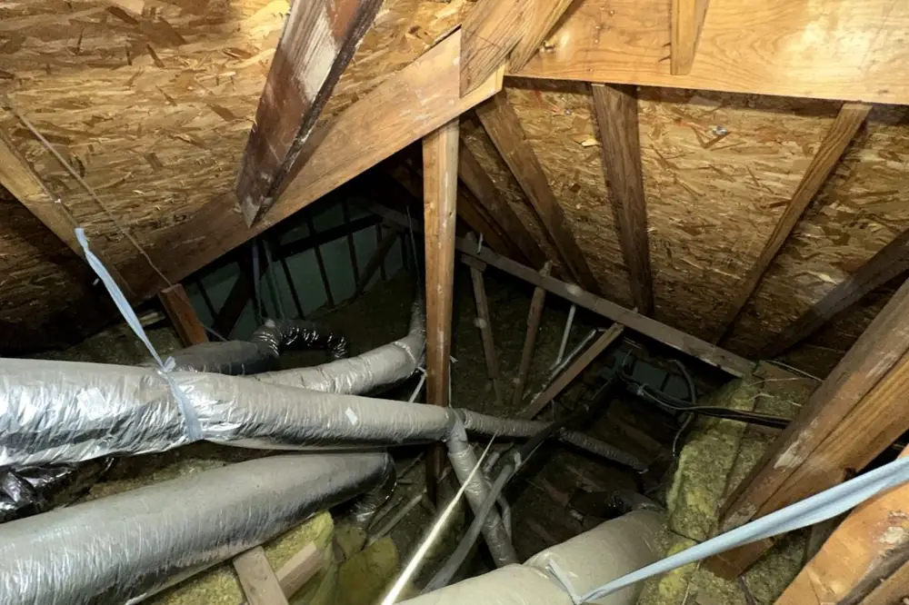 Attic before: thin insulation over ceiling joists