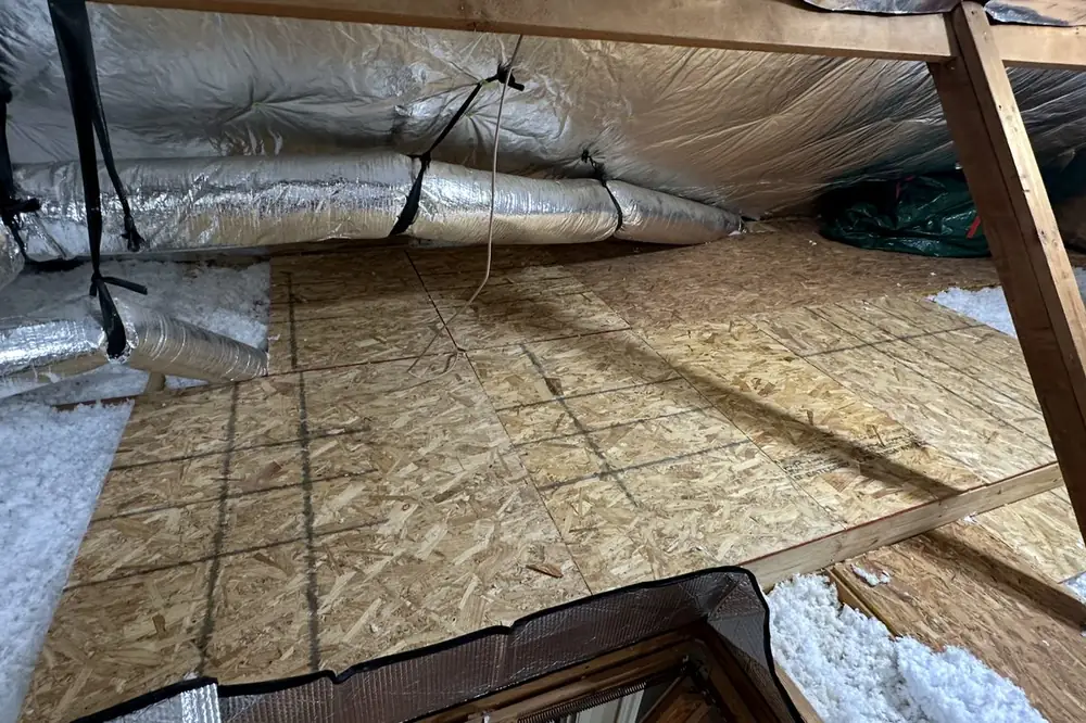Same attic after: reflective barrier installed across the roofline