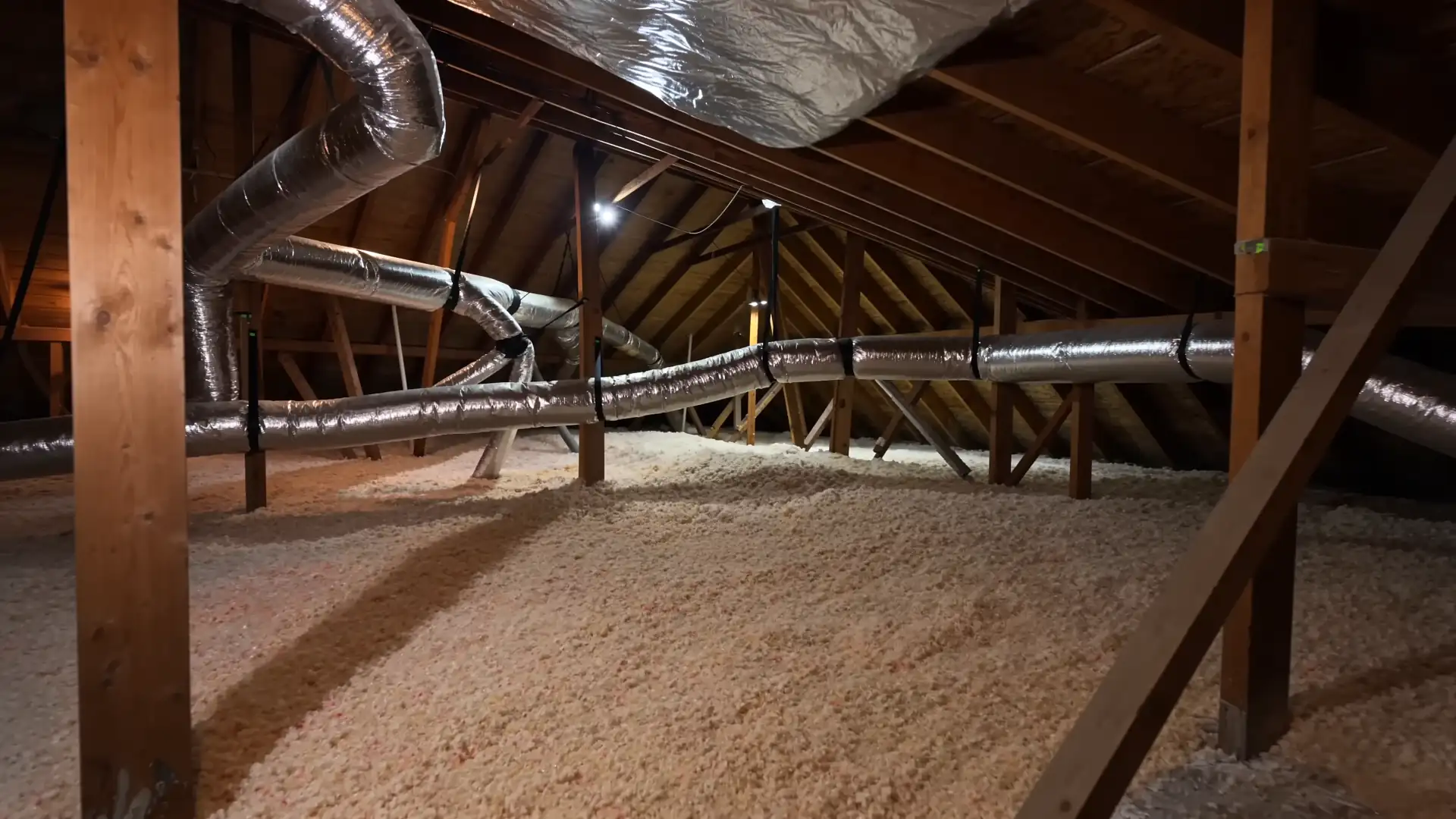 A Houston attic before insulation work: bare rafters and old, thin insulation